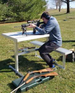 Right handed marksman using the all weather aluminum outdoor shooting bench