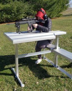 Left handed Female Marksman on aluminum shooting bench