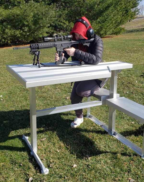 Left handed Female Marksman on aluminum shooting bench