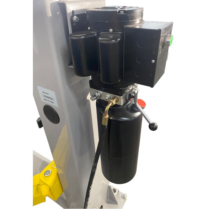 Triumph 9,000 lb. floor plate car lift gray and yellow with hydraulic power unit.